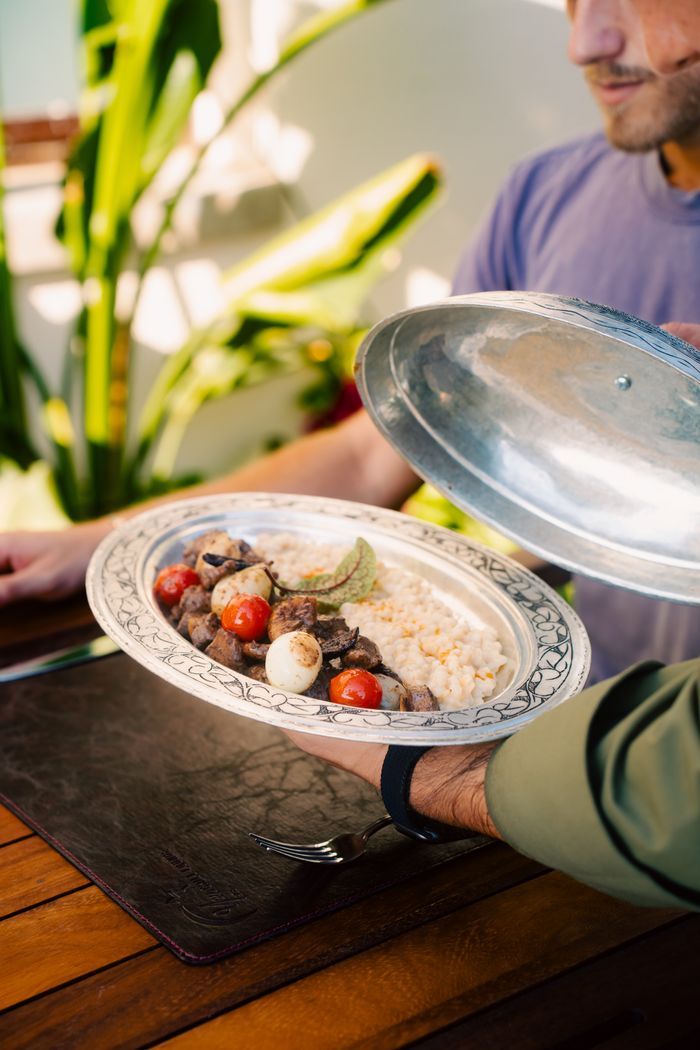 Delicious Turkish dish with meat and vegetables served outdoors in Side, Antalya.